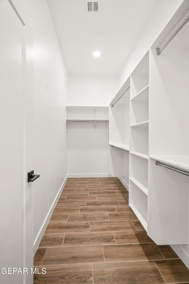 walk in closet with visible vents and wood tiled floor