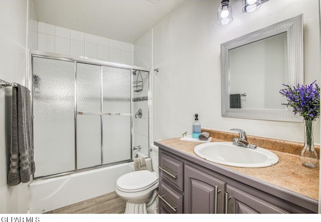 full bathroom with vanity, toilet, and shower / bath combination with glass door