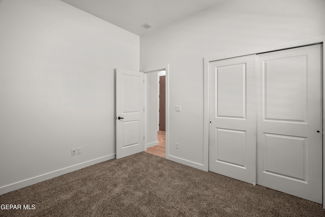 unfurnished bedroom with a closet, visible vents, baseboards, and carpet floors