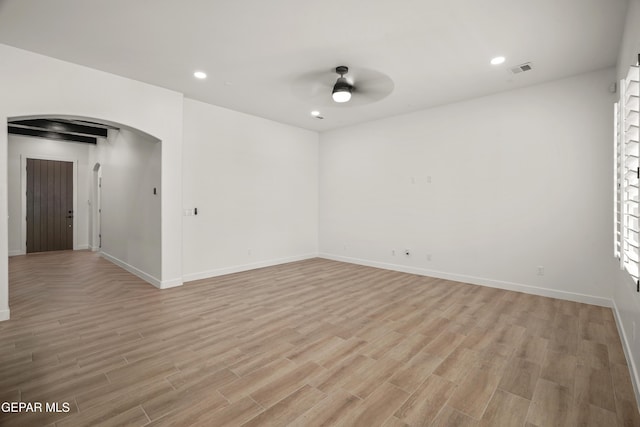 spare room featuring recessed lighting, light wood-type flooring, arched walkways, and a ceiling fan