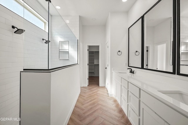 full bath with a sink, a spacious closet, walk in shower, and double vanity