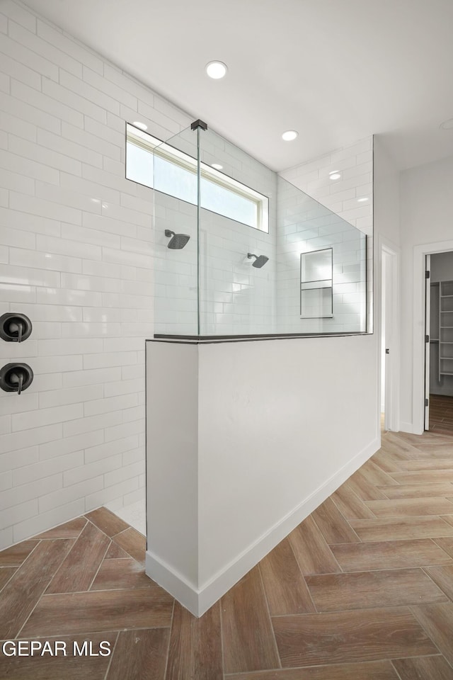 full bath with recessed lighting, baseboards, and a walk in shower