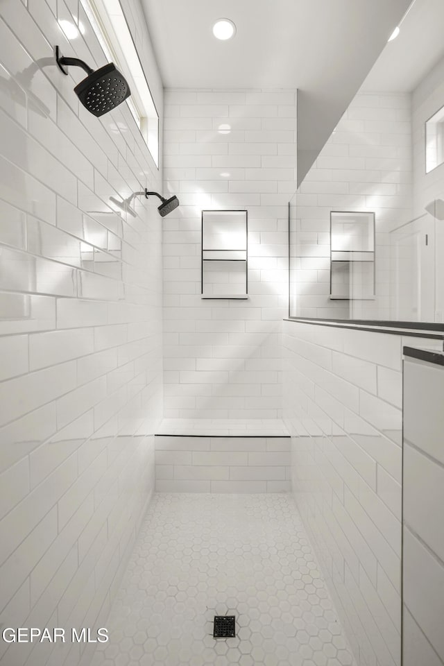 bathroom featuring recessed lighting and a tile shower