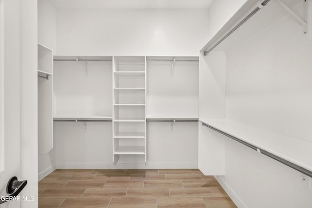 spacious closet with wood tiled floor