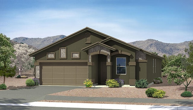 view of front facade with a mountain view, stucco siding, driveway, and a garage