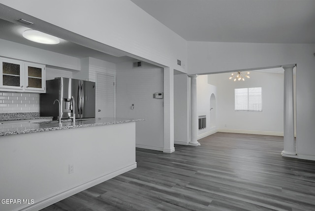 kitchen with visible vents, glass insert cabinets, stainless steel fridge with ice dispenser, and ornate columns