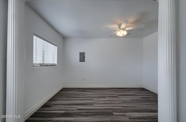 unfurnished room with electric panel, baseboards, dark wood-style flooring, and ceiling fan