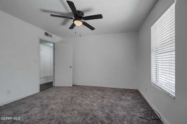 unfurnished bedroom featuring visible vents, a ceiling fan, baseboards, and carpet floors