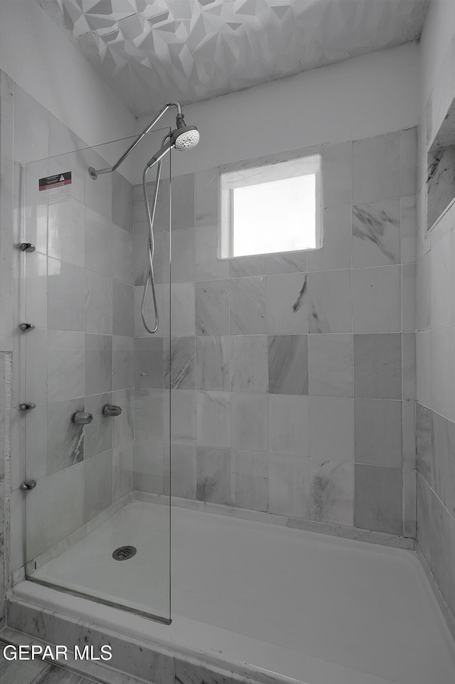 full bath with a tile shower