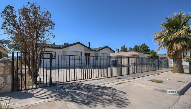 view of front facade with a fenced front yard and a gate