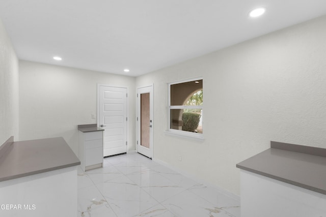 dining area featuring recessed lighting, marble finish floor, and baseboards