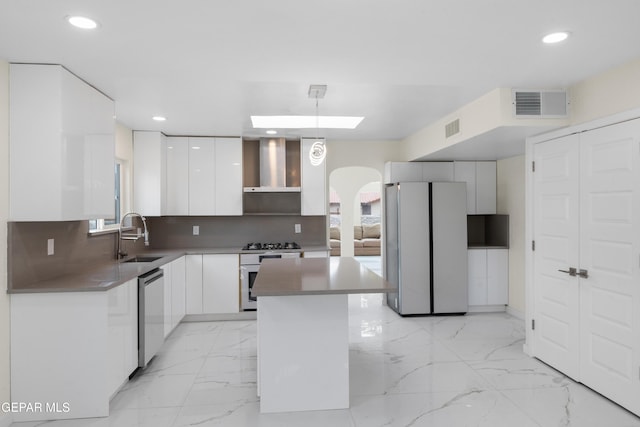 kitchen with wall chimney range hood, marble finish floor, white appliances, modern cabinets, and a sink