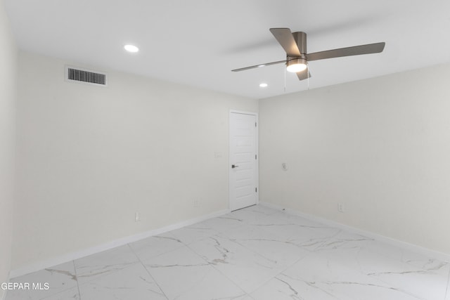 empty room featuring visible vents, recessed lighting, marble finish floor, and baseboards