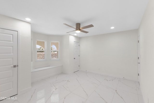 spare room featuring recessed lighting, baseboards, marble finish floor, and a ceiling fan