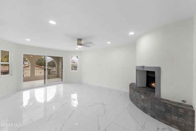 living area featuring marble finish floor, recessed lighting, a lit fireplace, baseboards, and ceiling fan