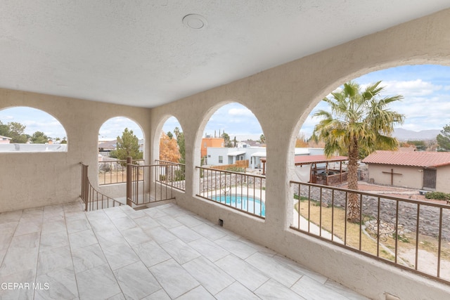 view of patio / terrace featuring a balcony and a fenced in pool