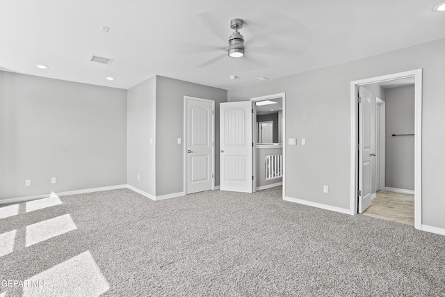 unfurnished bedroom with visible vents, ensuite bath, recessed lighting, carpet floors, and baseboards