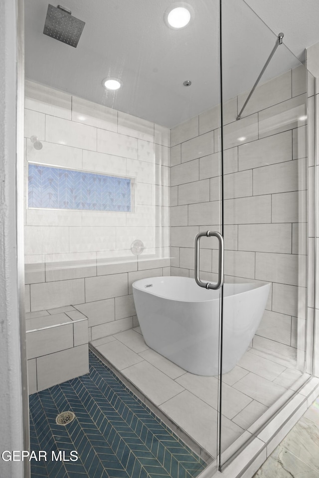 bathroom with a freestanding tub, recessed lighting, and a stall shower