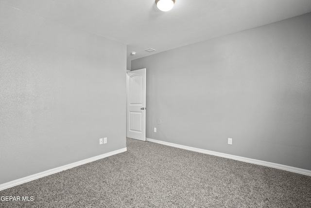 empty room with carpet and baseboards