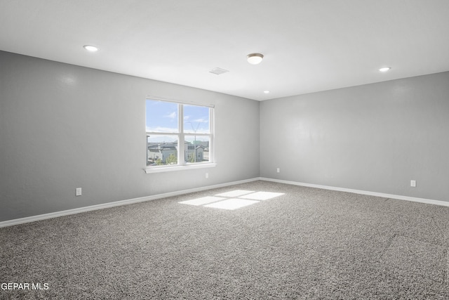 spare room with recessed lighting, baseboards, and carpet floors