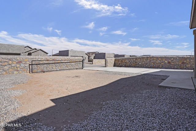 view of yard with fence and a gate