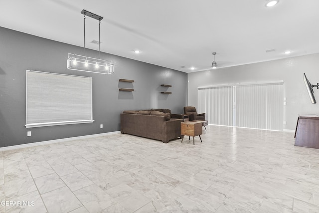 living area with visible vents, baseboards, recessed lighting, ceiling fan, and marble finish floor