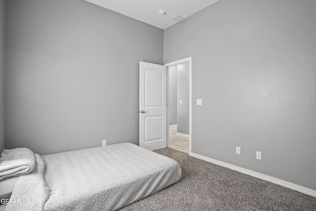 carpeted bedroom with baseboards