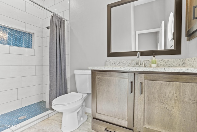 bathroom featuring vanity, toilet, and a stall shower