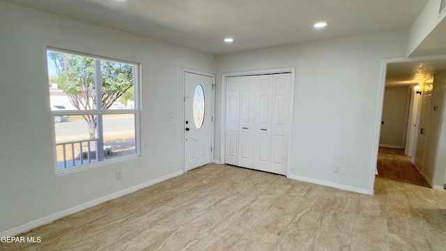 foyer with recessed lighting, visible vents, and baseboards