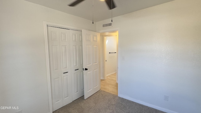 unfurnished bedroom featuring a ceiling fan, baseboards, visible vents, carpet floors, and a closet