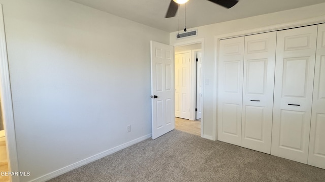 unfurnished bedroom with visible vents, a ceiling fan, a closet, carpet floors, and baseboards