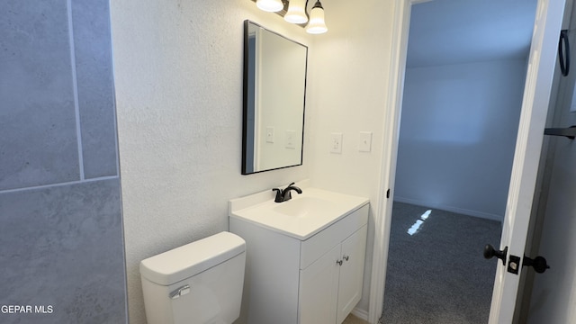 half bath featuring toilet and vanity