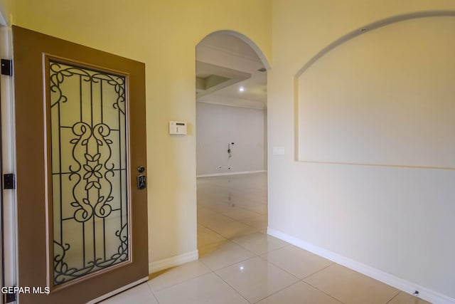 entrance foyer with light tile patterned flooring and baseboards