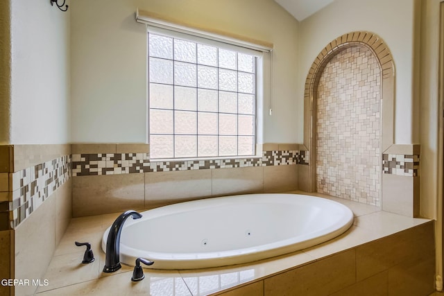 full bath featuring lofted ceiling and a bath