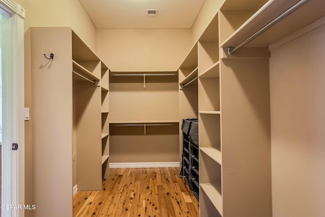 walk in closet featuring visible vents and wood finished floors