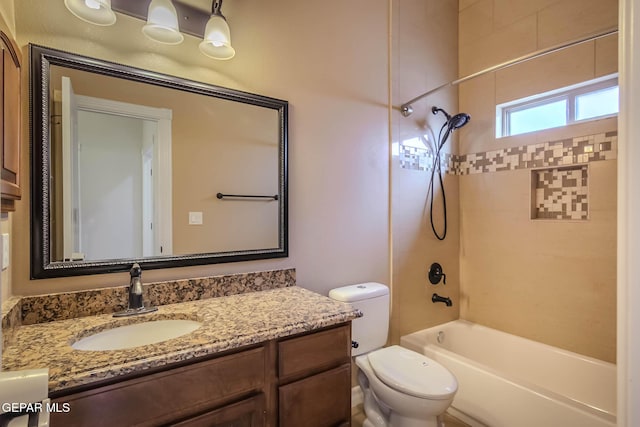 bathroom featuring vanity, toilet, and shower / washtub combination