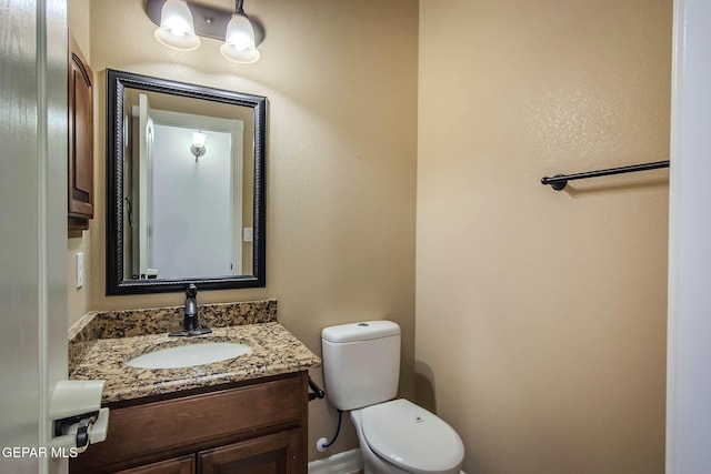 bathroom with toilet and vanity