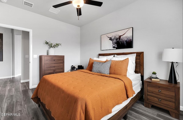 bedroom featuring ceiling fan, visible vents, baseboards, and wood finished floors