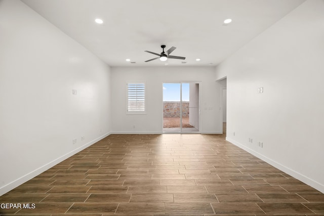 empty room with ceiling fan, recessed lighting, baseboards, and wood finish floors