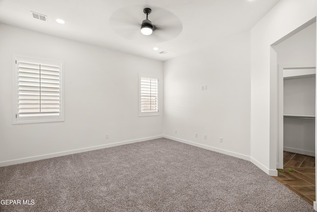 empty room with visible vents, recessed lighting, carpet flooring, baseboards, and ceiling fan