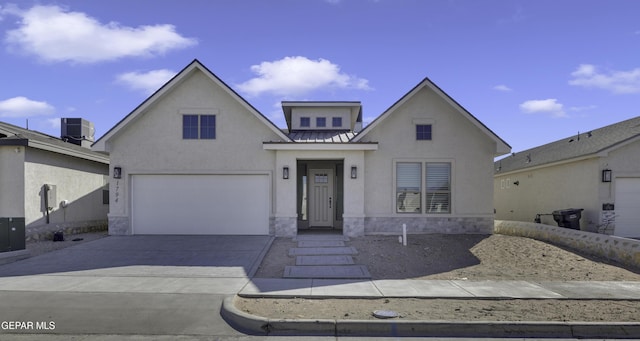 view of front of home with central air condition unit, concrete driveway, stucco siding, metal roof, and stone siding