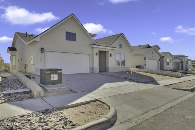 view of front of home with a shingled roof, stone siding, driveway, and stucco siding