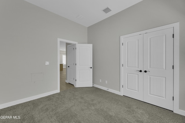 unfurnished bedroom featuring visible vents, baseboards, a closet, and carpet flooring