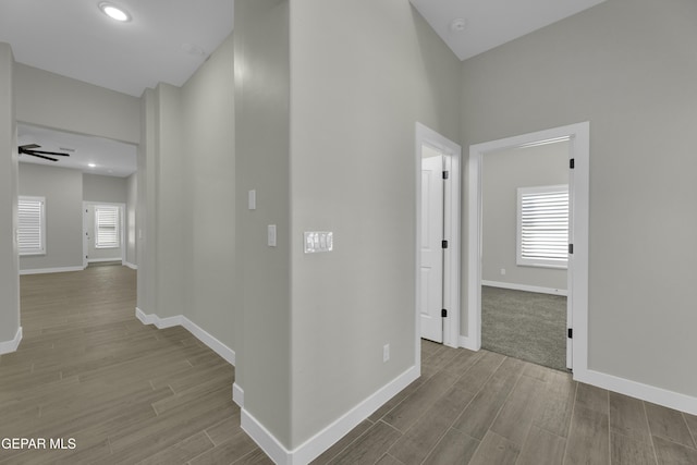 corridor with recessed lighting, baseboards, and wood finished floors