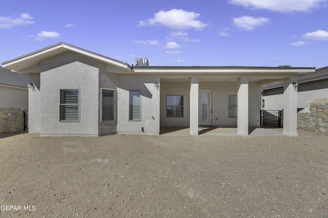 back of house featuring stucco siding and a patio