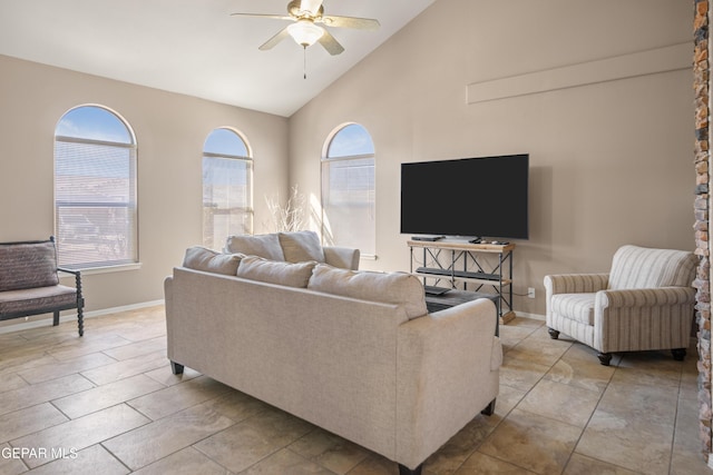 living room with plenty of natural light, baseboards, and a ceiling fan