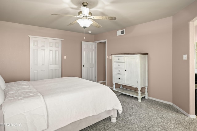 carpeted bedroom featuring a ceiling fan, baseboards, visible vents, and a closet