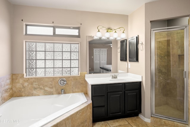 bathroom featuring tile patterned flooring, a shower stall, a bath, and vanity