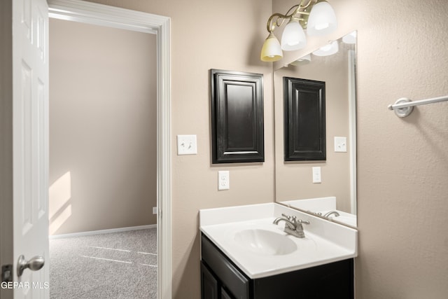 bathroom with vanity and baseboards