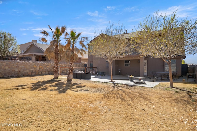 back of house featuring stucco siding, a patio, and fence